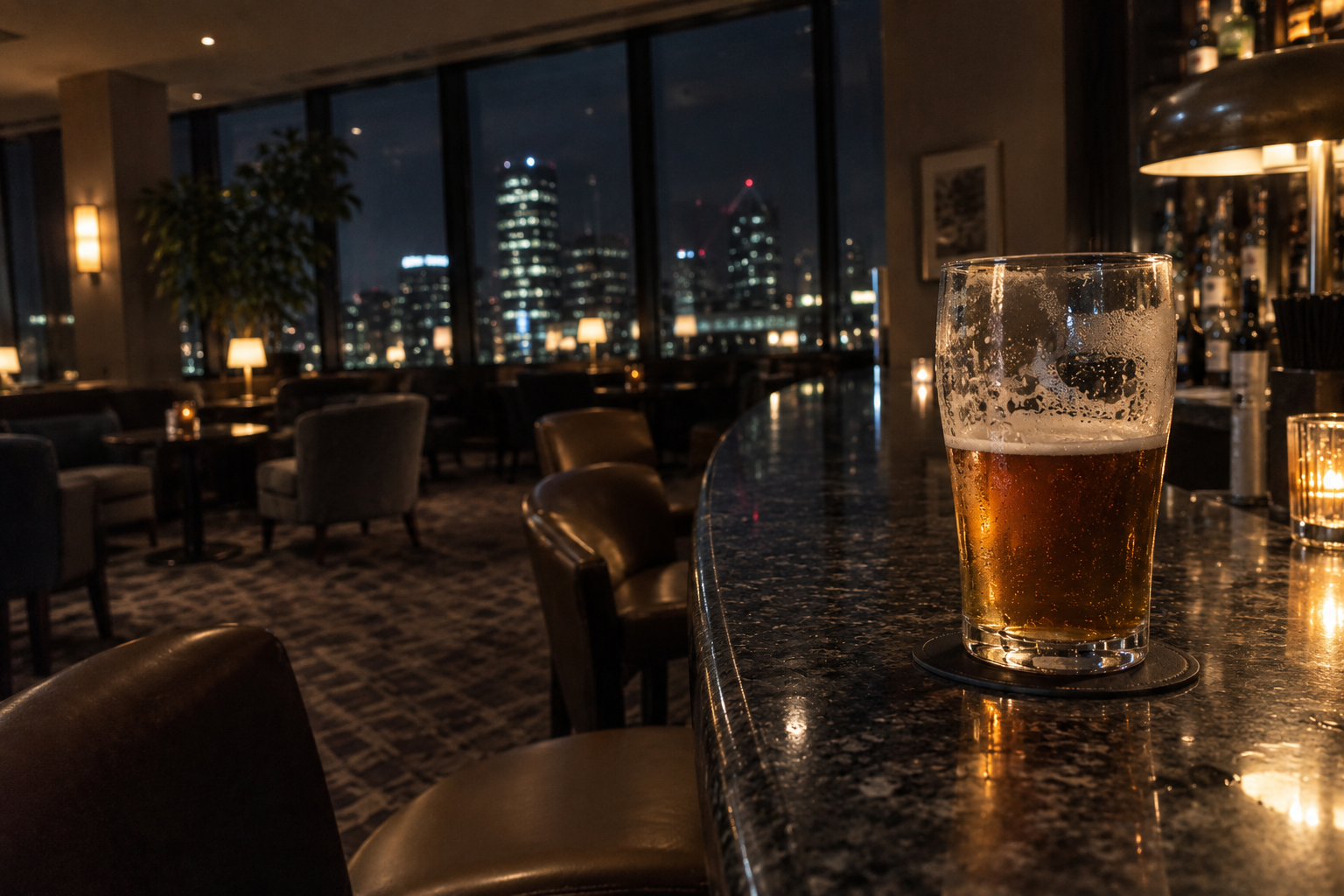 A half-finished pint in a quiet hotel bar at night